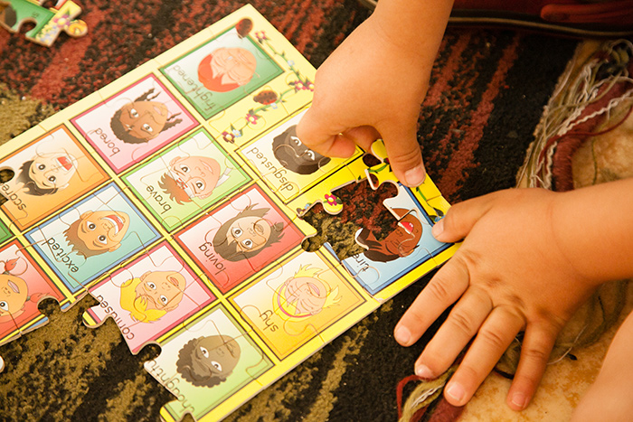 Child playing with a jigsaw puzzle